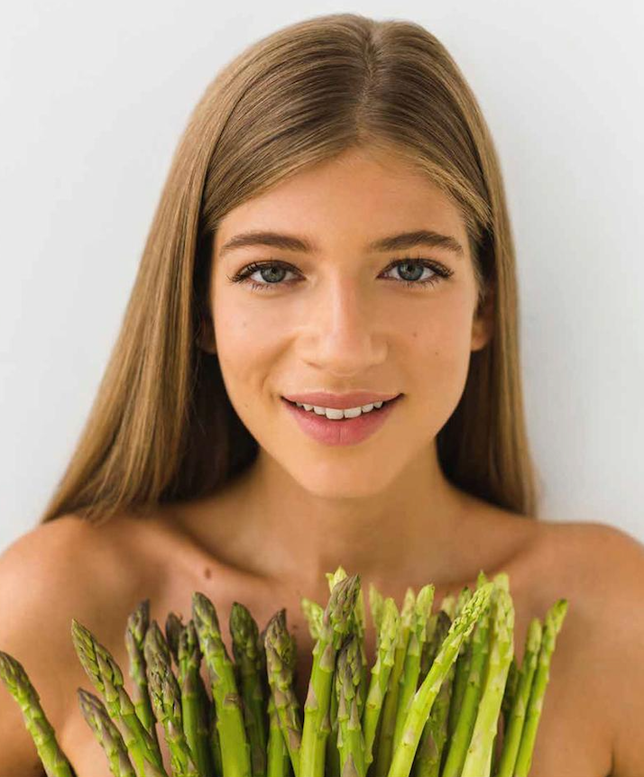 HOW TO EAT — portrait behind asparagus stems