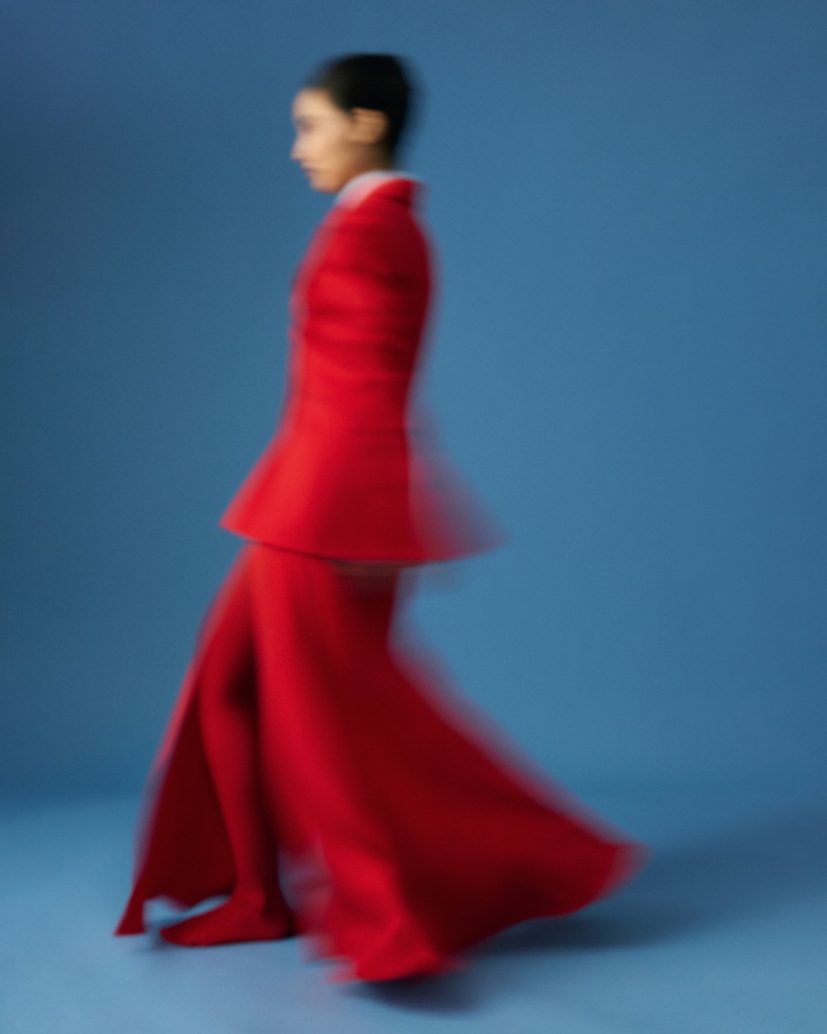 MIOGI LI — campaign, red tailoring in motion against blue