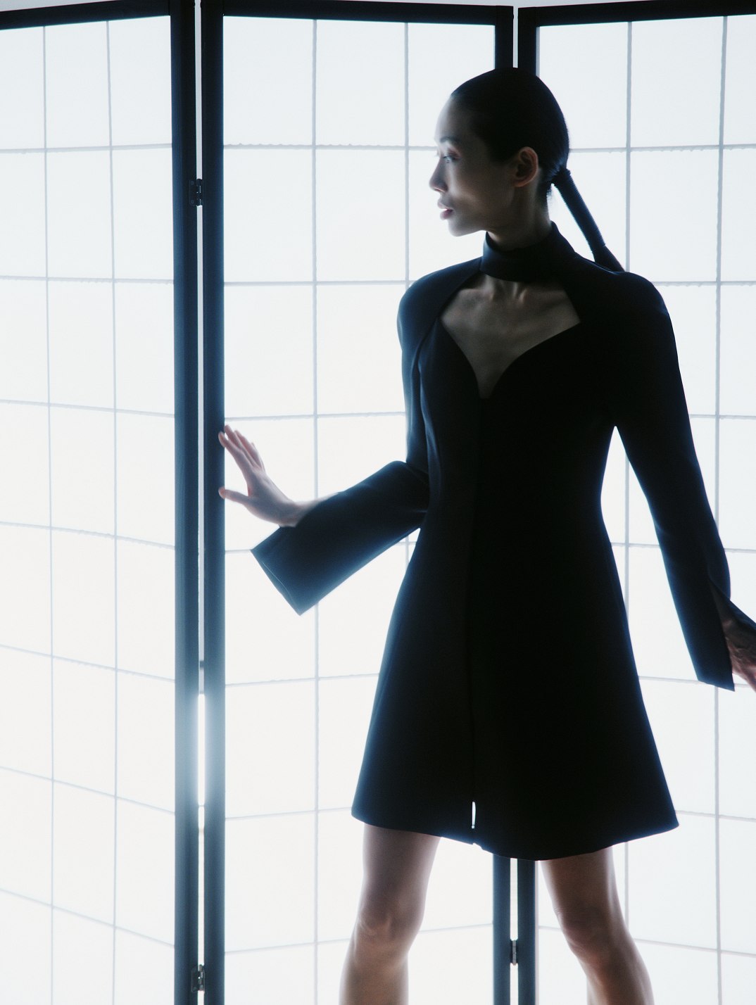 MIOGI LI — black dress with a cut-out collar against a shoji screen