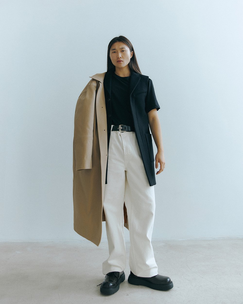 Private portrait — standing look with a camel coat over the shoulder