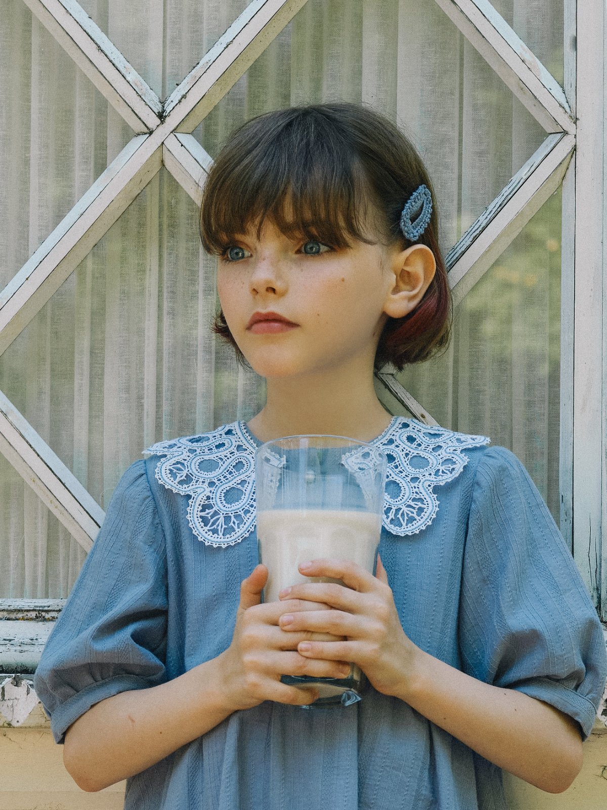 POLUSHA — campaign, girl in a blue dress with a lace collar holding a glass of milk