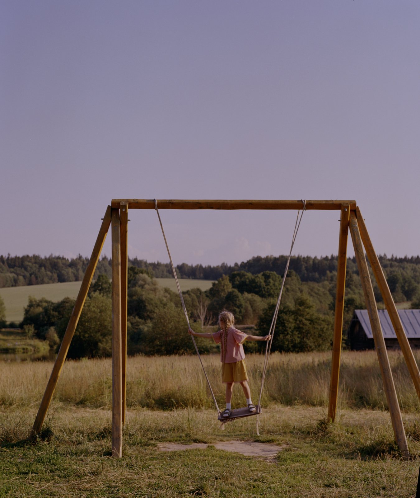 POLUSHA — campaign, child on a wooden swing in a summer field
