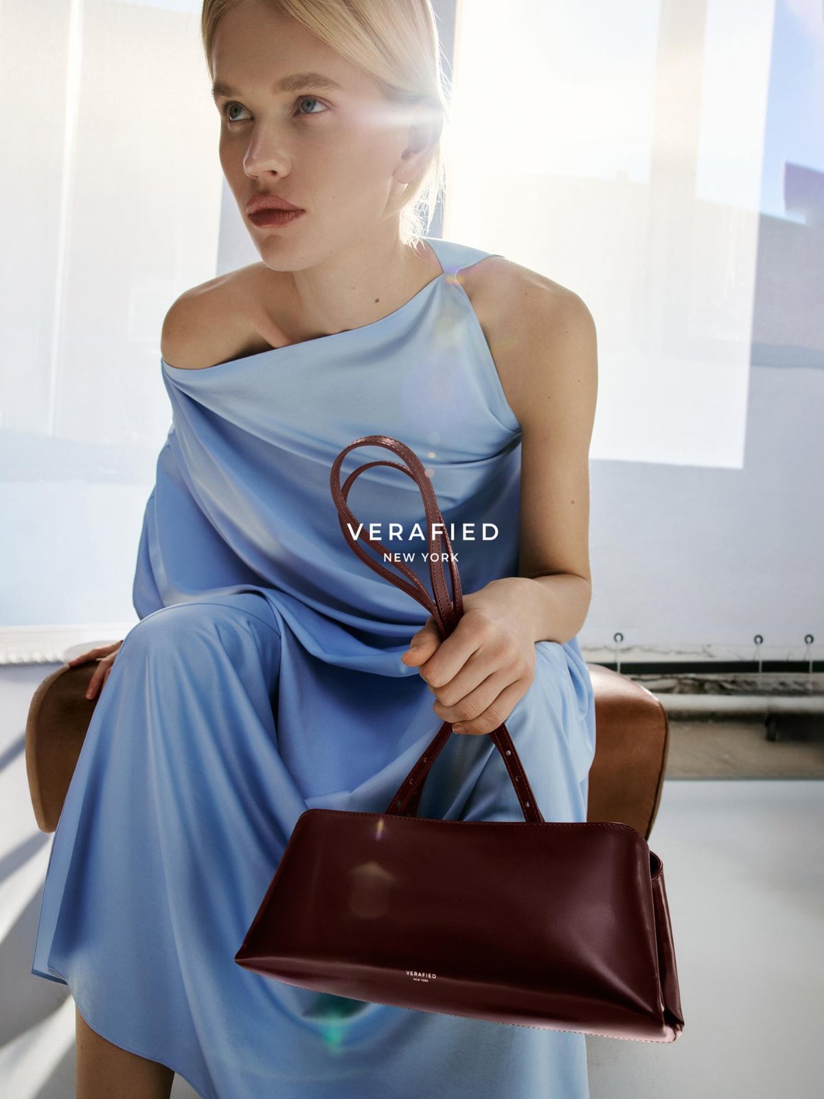 VERAFIED New York — campaign, cornflower satin dress with a burgundy leather bag